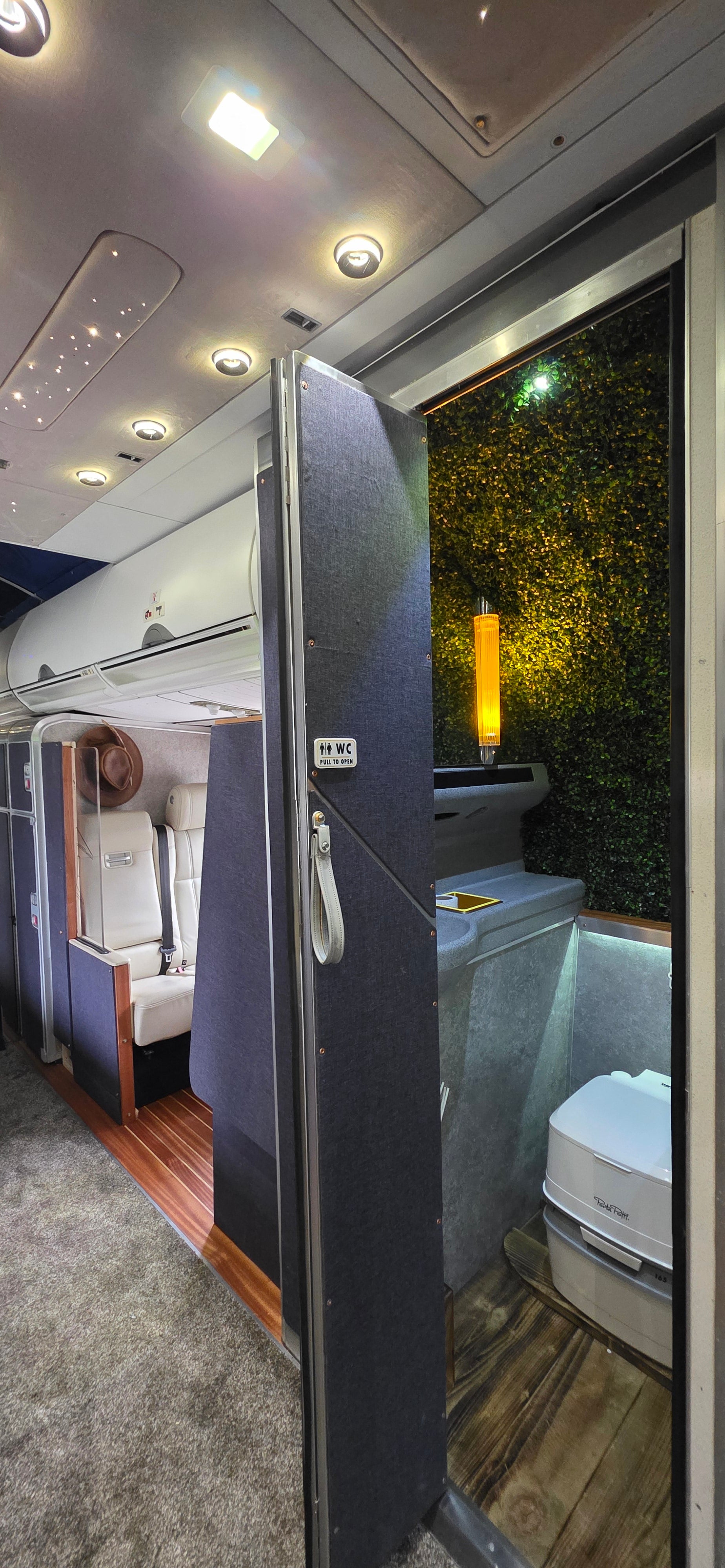 Interior view of a vehicle with an open door, showing a bed and interior details. Interior of a boeing 717 private jet first class cabin interior design